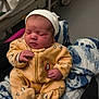 Alma a rejoint le concours — aidez-le/la à gagner de superbes lots ! newborn, baby, infant, yellow_onesie, penguin_prints, white_hat, blanket, hospital_bed, sleeping, cozy, hands, feet, person, indoor, soft, cute, child, resting, bed, clothing