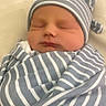 John Thomas joined the competition — help win amazing prizes! baby, bed, blanket, calm, closed_eyes, cozy, cute, face, headwear, indoors, infant, newborn, peaceful, photography, portrait, resting, sleeping, striped_clothing, striped_hat, swaddled