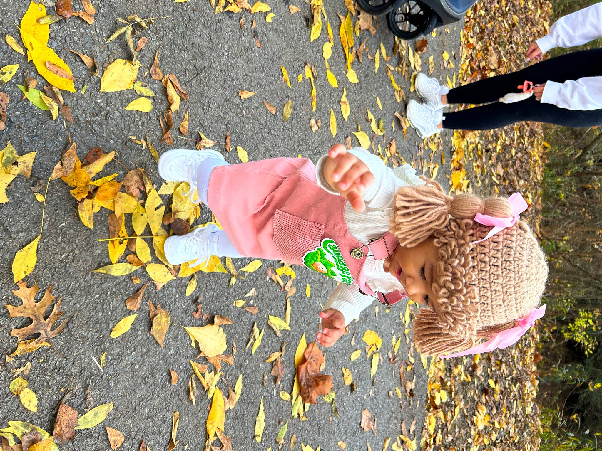 Alaina is registered to the contest to win money with this photo: adaptation, asphalt, child, deciduous, fun, grass, happy, headwear, human_leg, leisure, people_in_nature, person, plant, road_surface, shadow, sidewalk, sneakers, tints_and_shades, toddler, tree