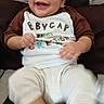 baby, child, smiling, happy, sitting, portrait, indoors, cushion, chair, clothing, shirt, pants, socks, face, hands, feet, infant, lifestyle, close_up, photography