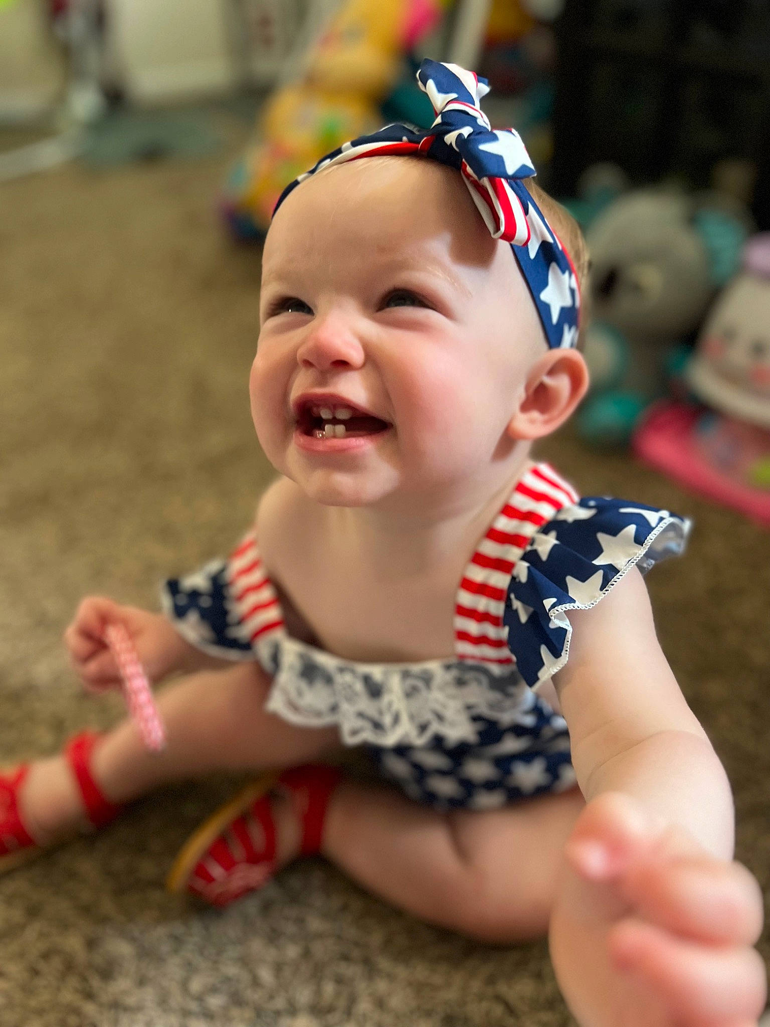 Madi is registered to the contest to win money with this photo: baby, baby_toddler_clothing, child, event, eyewear, fashion_accessory, finger, fun, grass, happy, headband, headpiece, jewellery, laugh, pattern, person, plant, recreation, smile, toddler