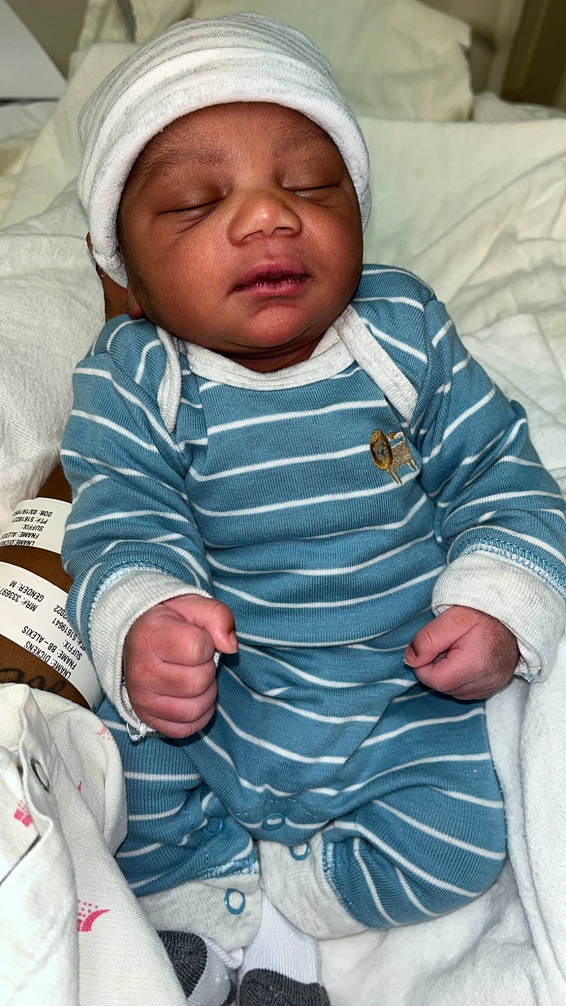 Juan is registered to the contest to win money with this photo: baby, baby_products, baby_toddler_clothing, cheek, child, collar, comfort, eye, face, finger, gesture, hand, headwear, linens, pattern, people, person, skin, sleeve, thumb