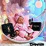 baby, pink_robe, towel_turban, hanging_chair, luxury_makeup, lipstick, compact, shopping_bag, glasses, soft_lighting, cushion, carpet, indoor, portrait, relaxing, cosmetics, sleeping, cozy, decor, child