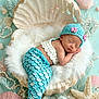 Ivy-Mai is registered to the contest to win money with this photo: newborn, baby, mermaid_costume, crochet, sleeping, clam_shell, starfish, seashells, pearls, pastel_colors, soft_texture, cute, infant, handmade, underwater_theme, decorative, portrait, resting, blue, white