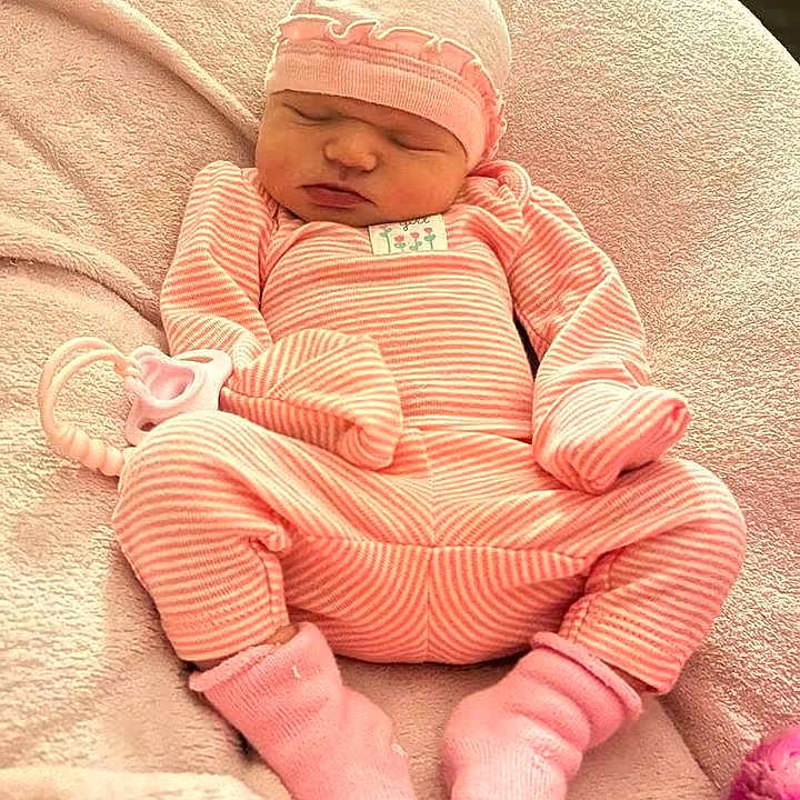 Emberley Hughes joined the competition — help win amazing prizes! baby, blanket, child, closed_eyes, cozy, face, hat, indoors, infant, lying_down, newborn, peaceful, pink, plush_toy, portrait, sleeping, socks, soft_lighting, striped_outfit, textile