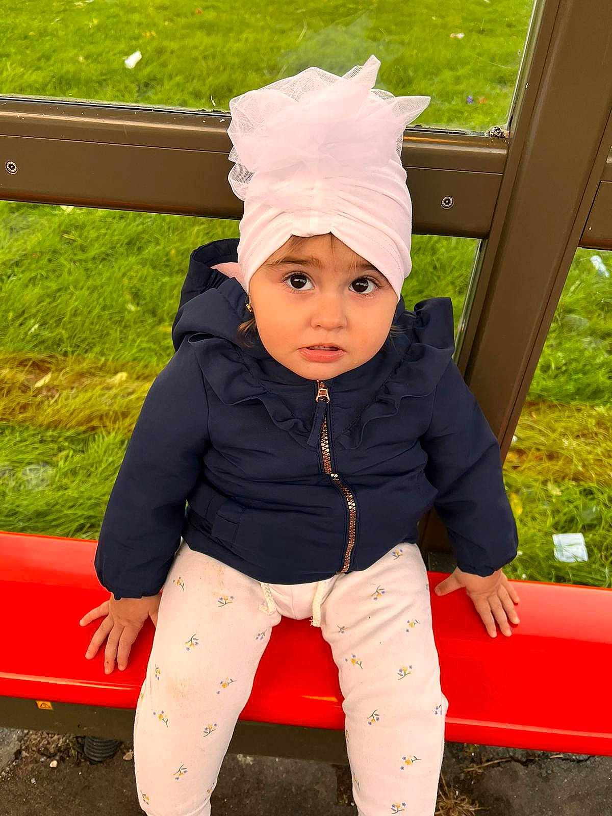 Aylin joined the competition — help win amazing prizes! baby, baby_toddler_clothing, cap, costume_hat, eye, fashion_accessory, fun, grass, happy, headgear, headwear, human_body, leisure, outerwear, person, plant, recreation, red, sleeve, toddler