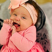 Kynslee joined the competition — help win amazing prizes! baby, infant, smiling, pink_clothing, headband, cute, happy, portrait, close_up, hands, red_hearts, soft_focus, child, toddler, fashion, indoors, warm_lighting, skin, face, expression