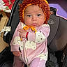 Mary Rose is registered to the contest to win money with this photo: baby, infant, child, lion_costume, lion_hat, orange, pink_outfit, car_seat, portrait, sitting, wide_eyes, serious_expression, cute, indoors, clothing, onesie, fluffy_mane, headband, vehicle_seat, photography