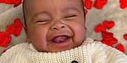 Bryson is registered to the contest to win money with this photo: baby, infant, smiling, laughing, cute, face, closeup, blanket, hearts, red_hearts, knit_sweater, sweater, cozy, soft_texture, tongue, eyes_closed, portrait, skin, hair, happy
