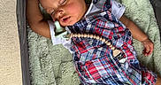 Bryson is registered to the contest to win money with this photo: baby, blanket, child, clothing, cute, face, footwear, hand, head, indoors, infant, nap, pacifier, peaceful, plaid_outfit, playpen, resting, sleeping, soft_texture, toy