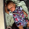baby, blanket, child, clothing, cute, face, footwear, hand, head, indoors, infant, nap, pacifier, peaceful, plaid_outfit, playpen, resting, sleeping, soft_texture, toy