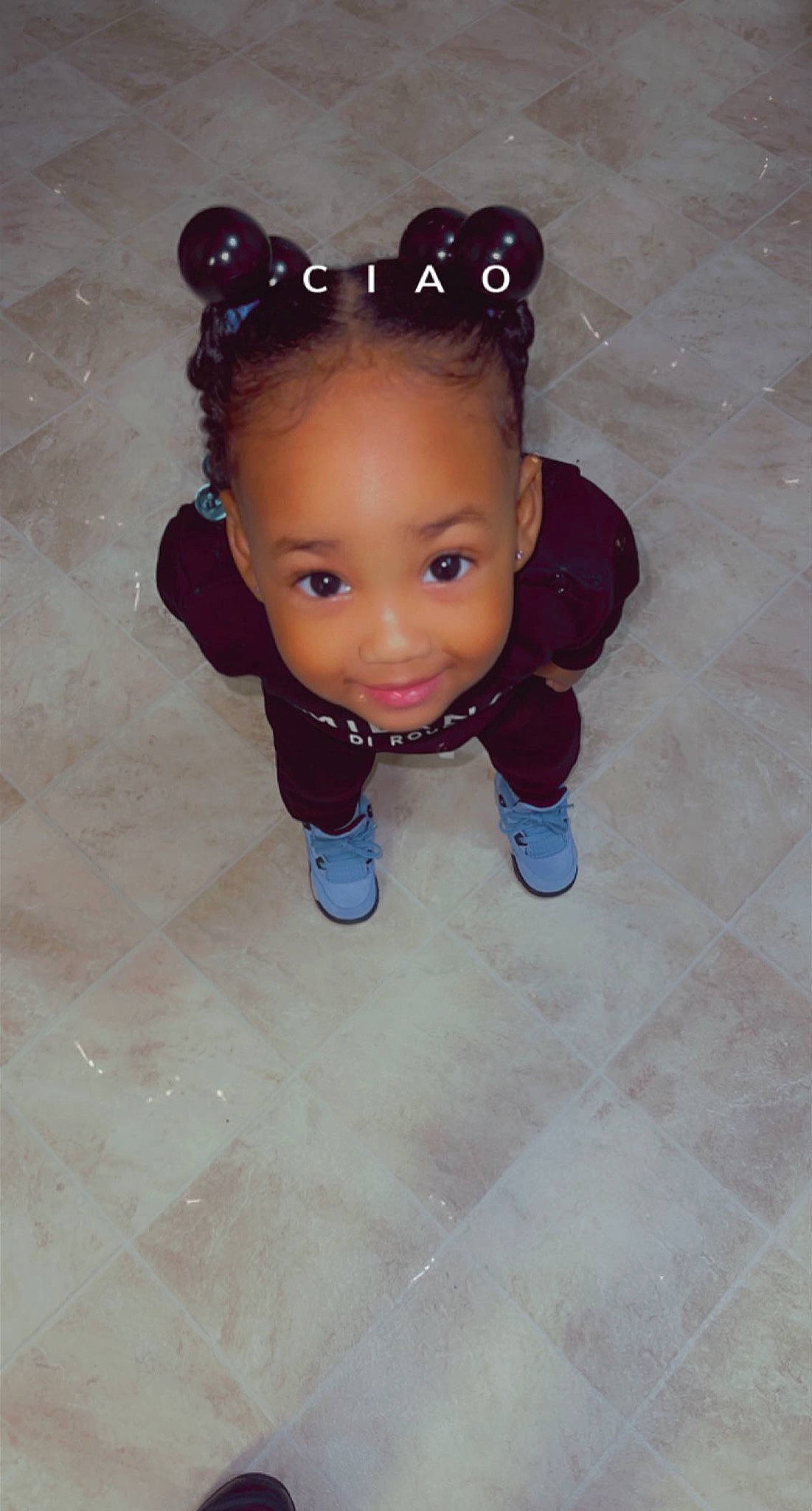 Raina is registered to the contest to win money with this photo: arm, baby_toddler_clothing, cheek, eye, face, flash_photography, flooring, gesture, goggles, happy, head, human_body, iris, joy, lip, nose, pattern, person, sleeve, smile