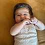 Charlie participe au concours pour gagner de l'argent avec cette photo : baby, infant, child, smiling, face, hand, skin, hair, clothing, sleeveless, lying_down, bed, fabric, cute, playful, portrait, closeup, expression, indoors, person