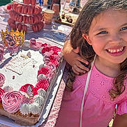 Lila participe au concours pour gagner de l'argent avec cette photo : child, girl, birthday_cake, pink_dress, party, macarons, cake, smile, celebration, frosting, table, food, outdoor, happy, person, dessert, crown, hand, sunlight, festive