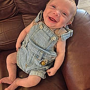 Riley joined the competition — help win amazing prizes! arms, baby, clothing, comfort, couch, cute, denim_overalls, face, happy, head, indoor, infant, joy, leather, legs, person, sitting, skin, smile, young_child