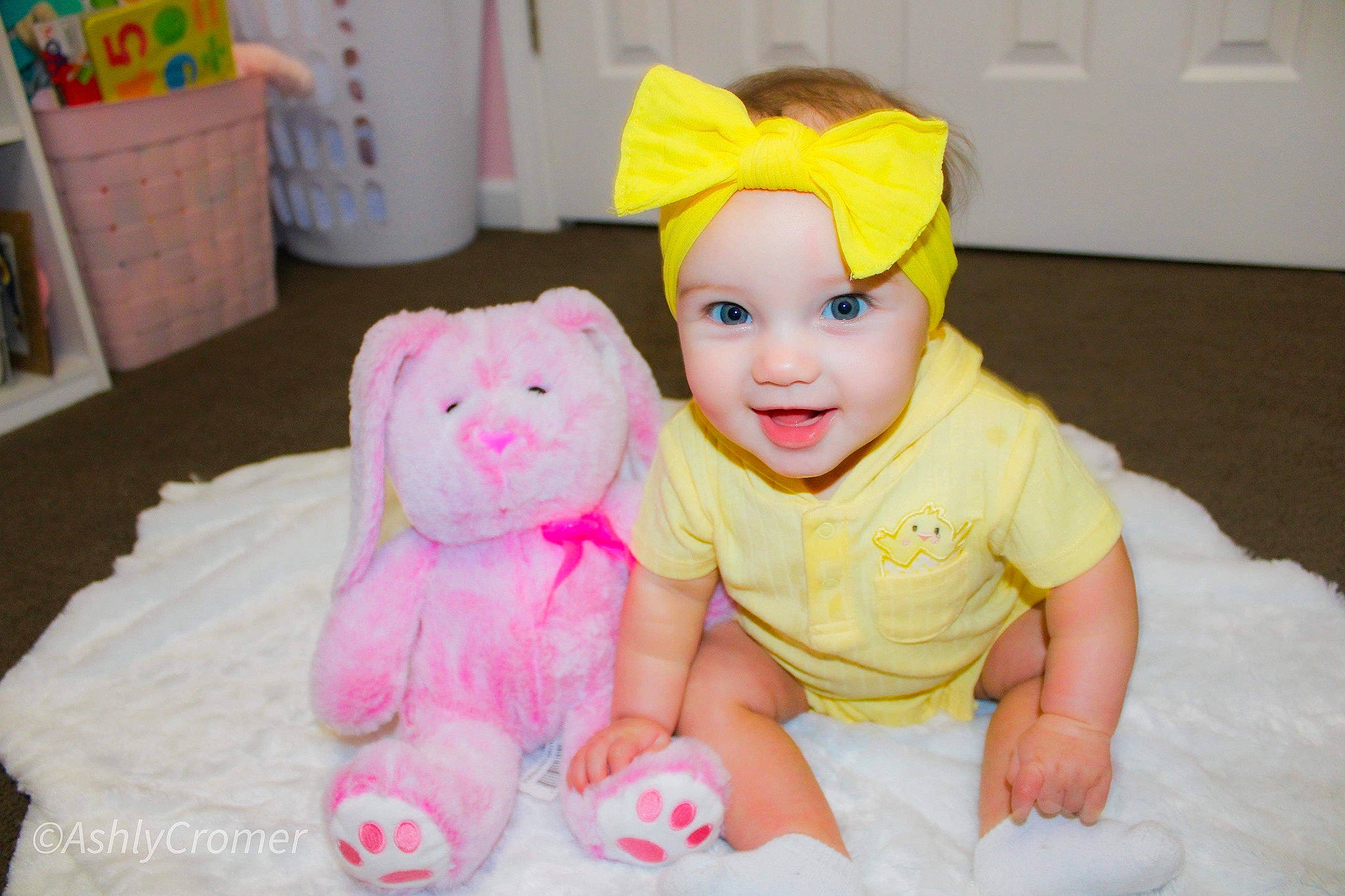 Avalee is registered to the contest to win money with this photo: baby, baby_toddler_clothing, cap, child, event, fun, happy, headgear, headwear, magenta, person, pink, room, skin, sleeve, smile, stuffed_toy, teddy_bear, textile, toddler