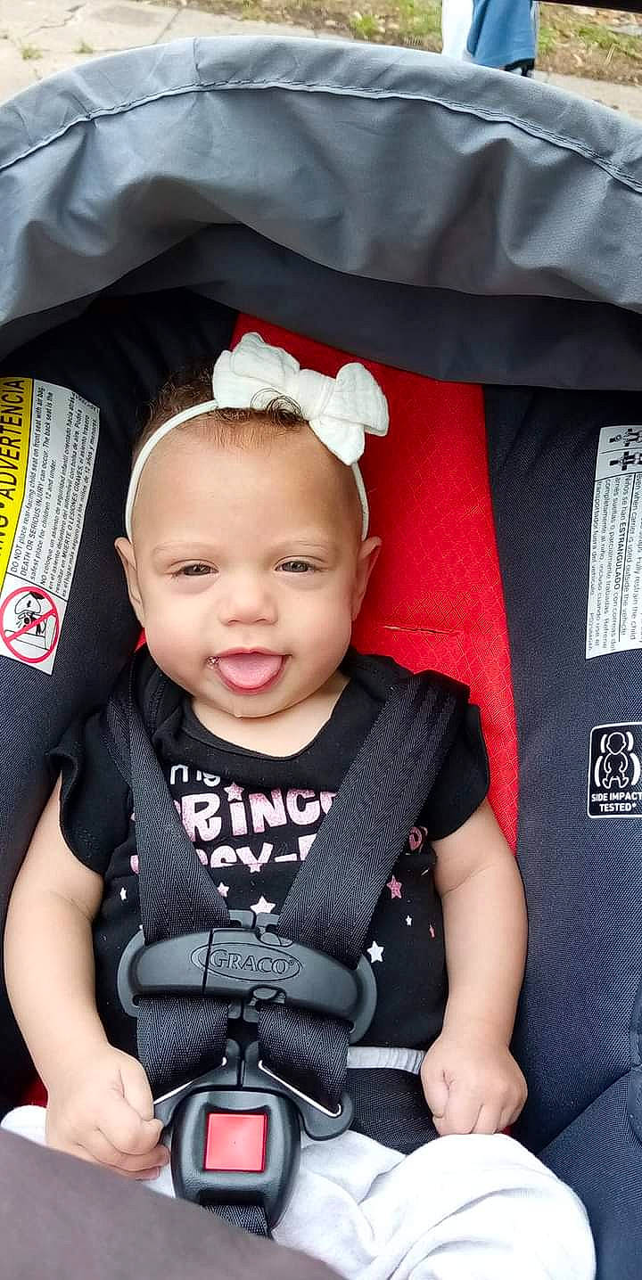 Skyla is registered to the contest to win money with this photo: baby, baby_carriage, baby_toddler_clothing, beauty, car_seat, cheek, child, chin, cool, eye, eyelash, happy, pattern, person, pink, product, red, sleeve, smile, toddler