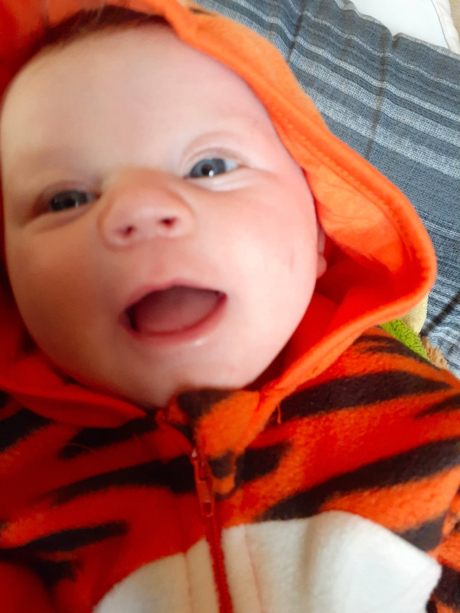 Annabeth is registered to the contest to win money with this photo: baby, cheek, child, chin, cool, eye, face, facial_expression, happy, head, laugh, lip, mouth, nose, orange, person, portrait_photography, skin, smile, toddler