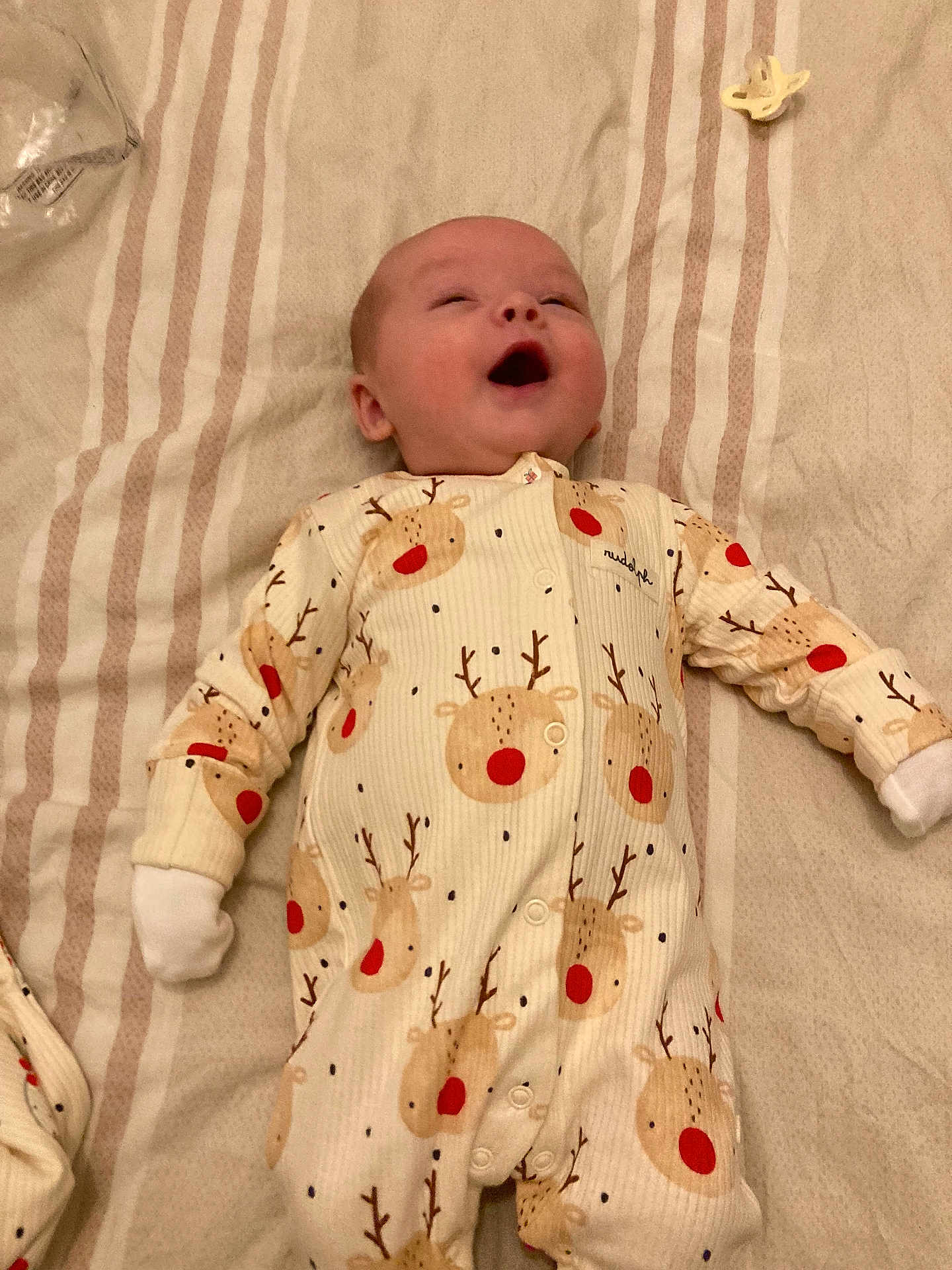 Hunter joined the competition — help win amazing prizes! baby, infant, onesie, reindeer_pattern, blanket, pacifier, smiling, happy, sleepwear, child, cute, lying_down, baby_clothes, cozy, indoor, soft_lighting, infant_garment, small_hands, peaceful, resting