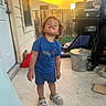 Asiah is registered to the contest to win money with this photo: blue_shirt, child, concrete_floor, curly_hair, daylight, door, fence, grill, happy, house, metal_trash_can, outdoor, patio, posing, shark_slippers, shorts, smiling, sunlight, toddler, window
