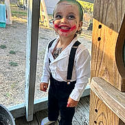 Asiah is registered to the contest to win money with this photo: black_pants, child, daylight, face_paint, green_hair, happy, joker_costume, outdoor, person, playful, porch, red_lipstick, smiling, socks, suspenders, tattoos, toddler, white_shirt, window_screen, wooden_floor