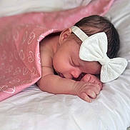 Arai joined the competition — help win amazing prizes! baby, newborn, sleeping, blanket, pink, white_bow, headband, soft, cute, peaceful, infant, hand, face, skin, hair, rest, closeup, child, portrait, cozy