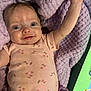 Laynna is registered to the contest to win money with this photo: arm_raised, baby, blanket, blue_eyes, child, close_up, cute, floral_pattern, happy, indoor, infant, lying_down, pacifier, person, pink_onesie, playful, smiling, soft_texture, tablet, young