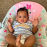 baby, infant, child, mickey_mouse, minnie_mouse, seat, striped_shirt, explorer_text, diaper, carpet, indoor, playful, happy, cute, hands, feet, smiling, person, young_child, colorful
