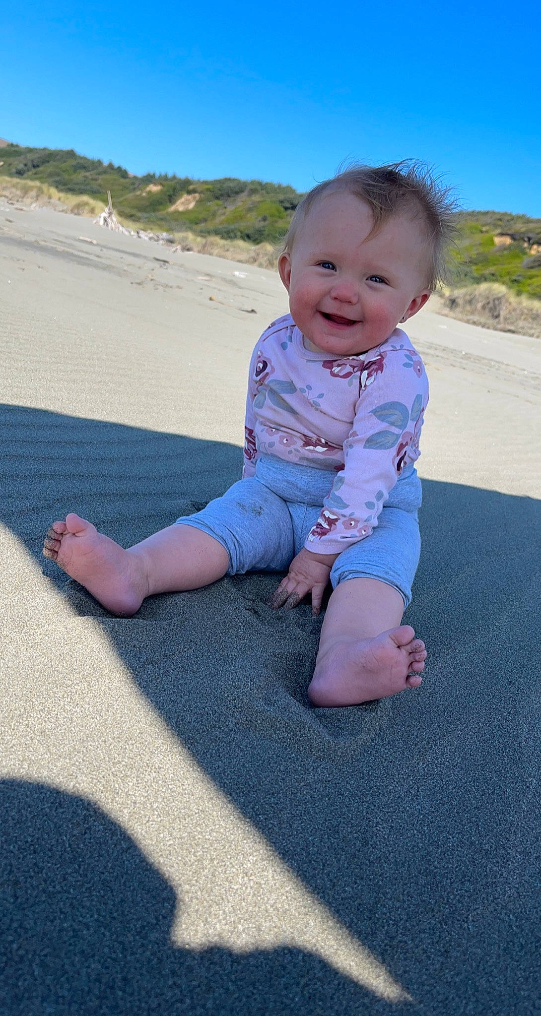 Divinity is registered to the contest to win money with this photo: asphalt, azure, baby, baby_toddler_clothing, barefoot, child, electric_blue, foot, fun, grass, happy, joy, leisure, person, recreation, sand, sitting, skin, sky, smile