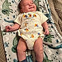 baby, infant, blanket, onesie, winnie_the_pooh, smile, socks, lying_down, cute, chubby, patterned_blanket, happy, child, indoor, soft_texture, cozy, comfort, portrait, person, clothing
