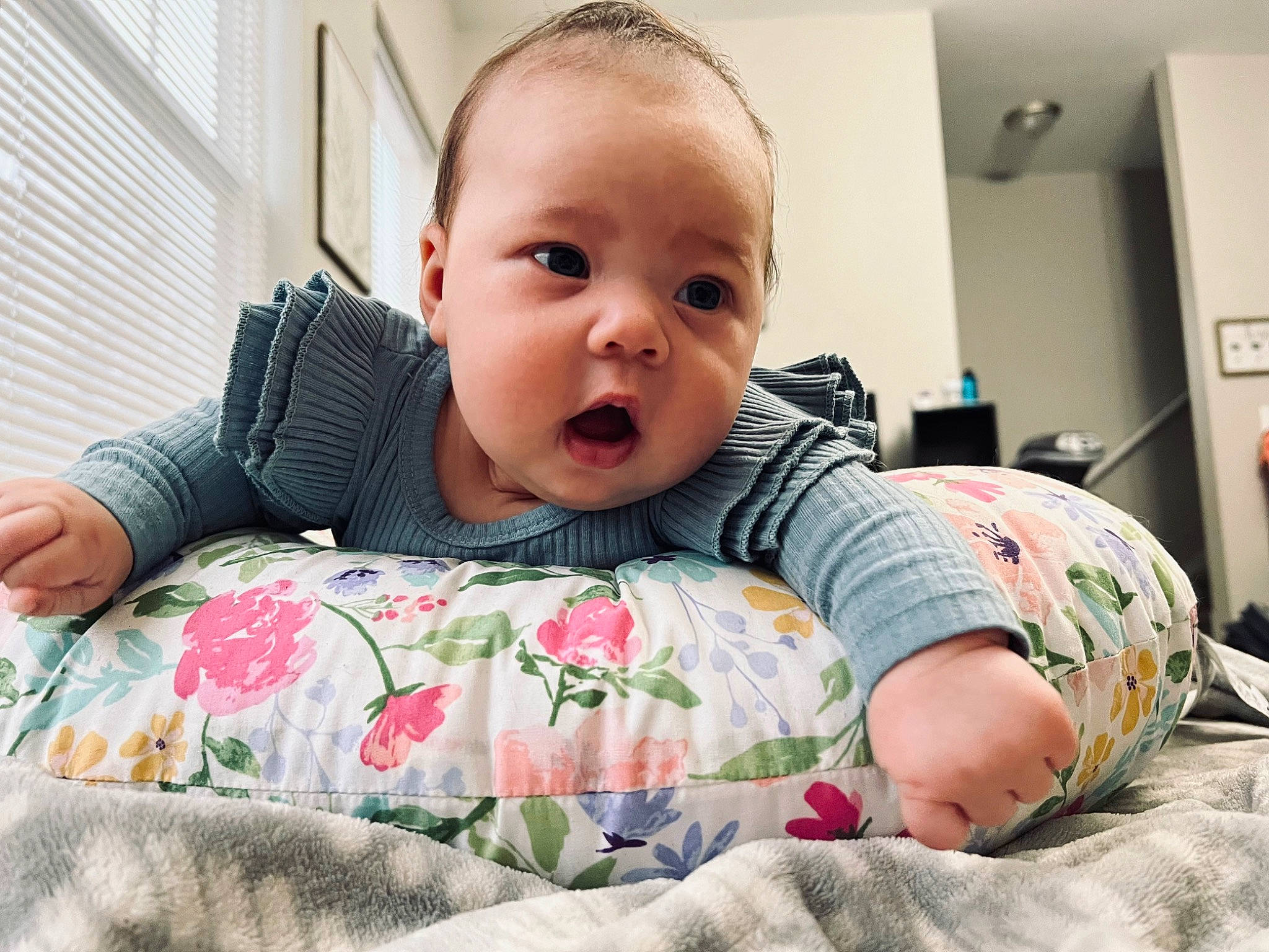 Haisleigh is registered to the contest to win money with this photo: baby, baby_toddler_clothing, bed, bedding, cheek, child, comfort, facial_expression, flooring, happy, linens, mouth, pattern, person, room, sitting, skin, sleeve, smile, t_shirt