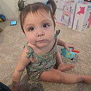 Sophia is registered to the contest to win money with this photo: architecture, baby, bodypart, box, building, clothing, crawling, electronics, face, finger, glove, hand, head, indoors, mobilephone, pants, person, phone, photography, portrait
