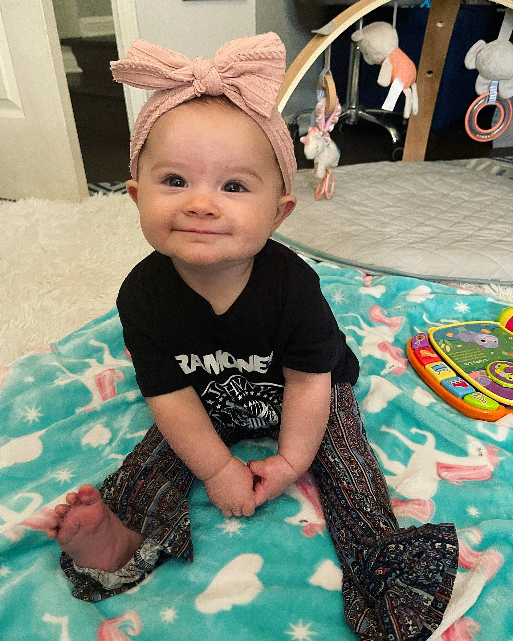 Austyn is registered to the contest to win money with this photo: baby, baby_toddler_clothing, cap, child, costume_hat, event, flooring, fun, green, happy, joy, linens, pattern, person, pink, skin, sleeve, smile, t_shirt, textile