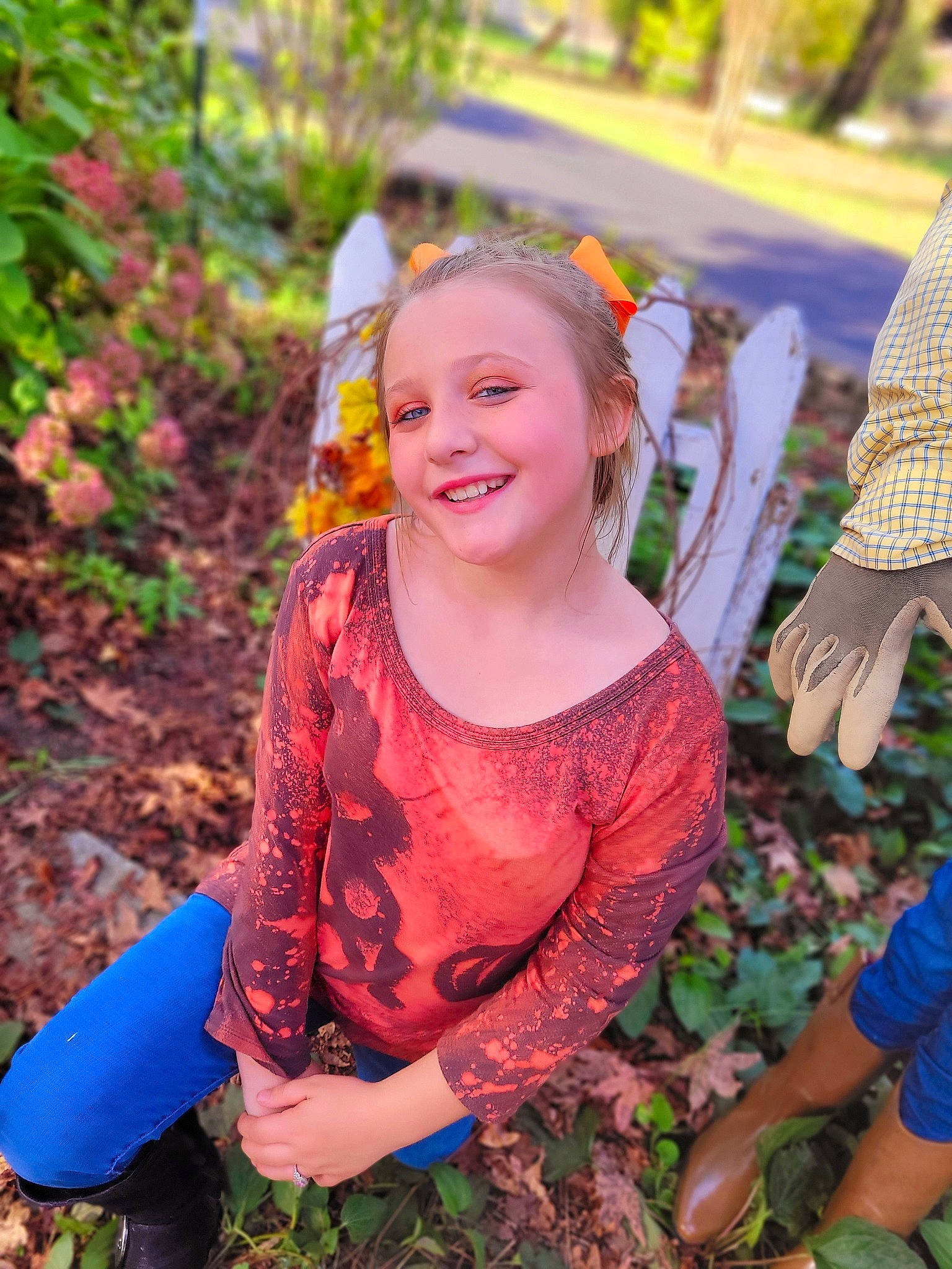 Jazmine joined the competition — help win amazing prizes! adaptation, child, costume, event, facial_expression, fun, grass, happy, jewellery, joy, leaf, leisure, orange, pattern, people_in_nature, person, plant, sitting, smile, soil