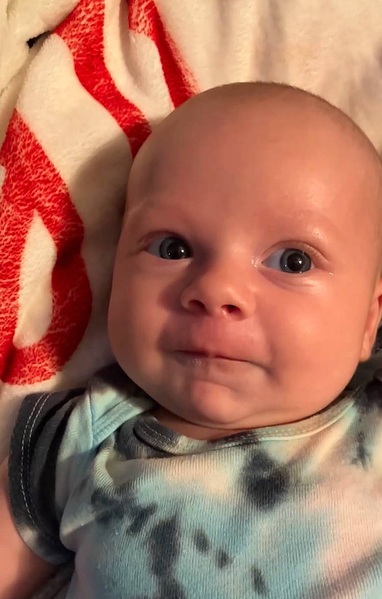 August is registered to the contest to win money with this photo: baby, baby_toddler_clothing, carmine, cheek, child, chin, close_up, eye, eyebrow, eyelash, face, happy, iris, linens, lip, nose, person, skin, sleeve, smile