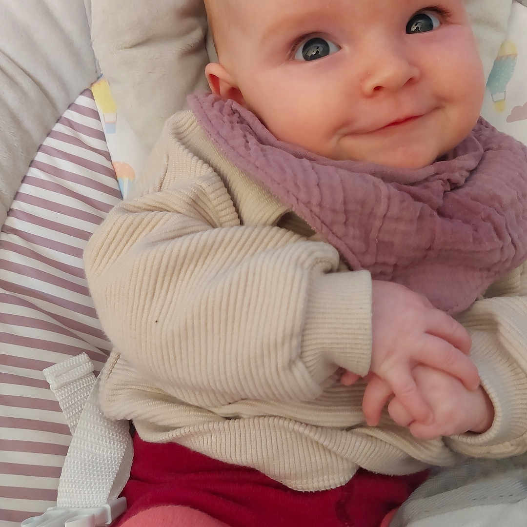 Ida-May joined the competition — help win amazing prizes! baby, baby_seat, child, clothing, comfort, cozy, cute, eyes, fabric, face, hands, indoor, infant, patterned, portrait, red, scarf, sitting, smiling, warm