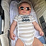Mathias participe au concours pour gagner de l'argent avec cette photo : arms, baby, car_seat, child, comfort, cute, face, head, indoor, infant, legs, onesie, person, pink, plush, relaxing, soft_toy, striped_clothing, sunglasses, superhero_theme