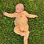 Mathias participe au concours pour gagner de l'argent avec cette photo : baby, child, clothing, cute, daylight, face, grass, greenery, head, infant, laying, nature, onesie, outdoor, peaceful, playful, relaxed, skin, stretching, sunshine