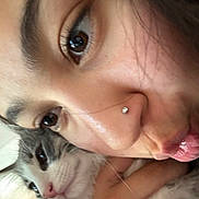 Mochi is registered to the contest to win money with this photo: human_face, cat, close_up, selfie, nose_piercing, brown_eyes, whiskers, cuddling, affectionate, indoor, portrait, lips, hand, fur, pet, playful, cozy, skin, eyelashes, nose