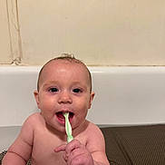 Adrastos is registered to the contest to win money with this photo: baby, bathtub, toothbrush, child, bathroom, water, skin, cute, smiling, red_cup, playful, young_child, hand, face, mouth, cleaning, hygiene, sitting, indoors, person