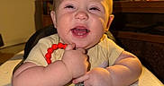 Adrastos is registered to the contest to win money with this photo: baby, child, smile, happy, indoor, high_chair, toy, red_beads, blue_octopus_toy, cheeks, face, person, furniture, lamp, sitting, closeup, cute, infant, playtime, home