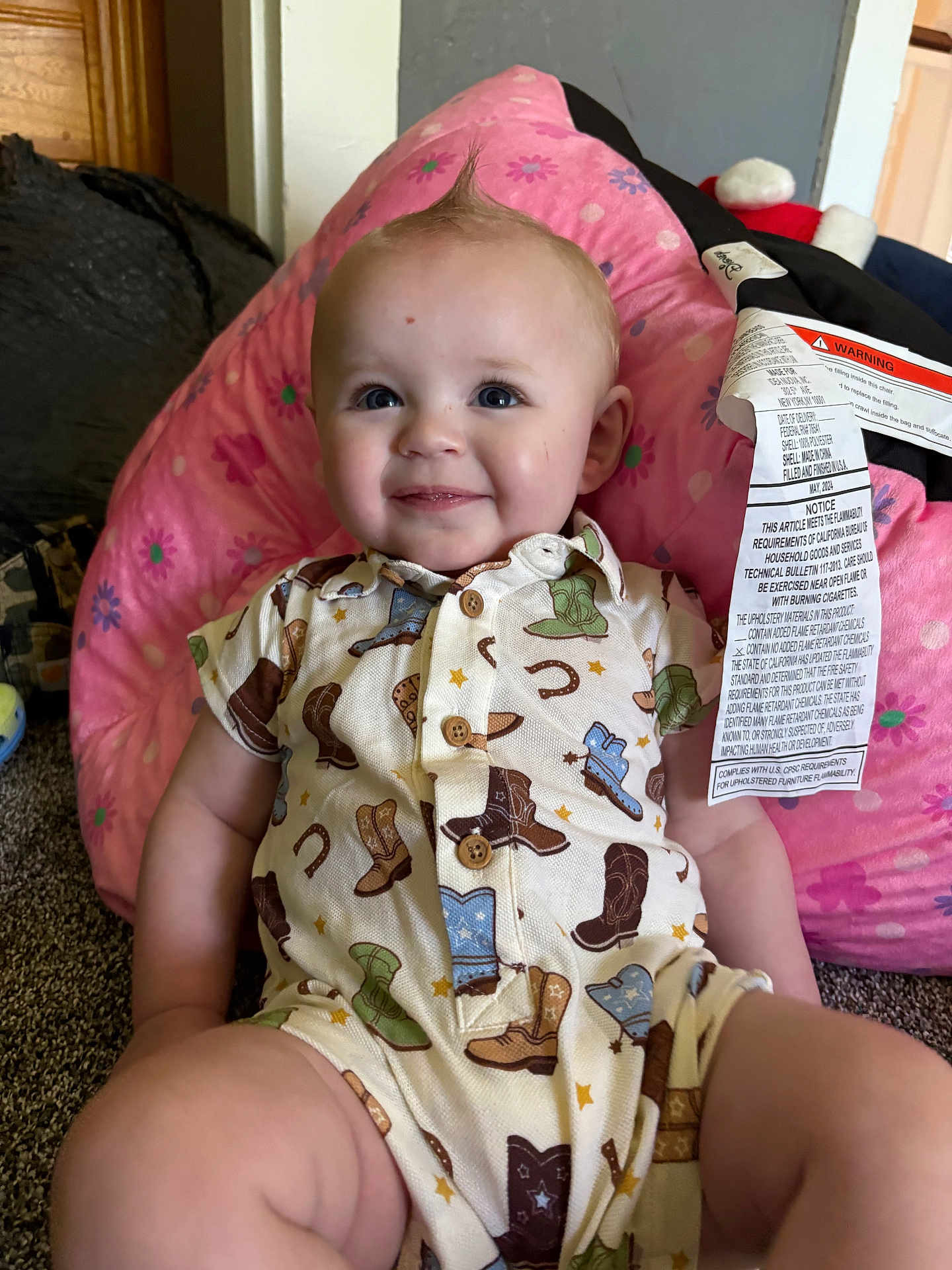 Ropyr joined the competition — help win amazing prizes! baby, child, smile, face, cushion, pink, flower_pattern, cowboy_boots, onesie, hair, mohawk, indoor, carpet, clothing, cute, infant, sitting, happy, person, room