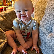 Ropyr joined the competition — help win amazing prizes! baby, smiling, child, onesie, couch, indoor, cozy, happy, sitting, cross_legged, face, furniture, home, cute, infant, toddler, person, skin, expression, light