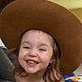 Rae joined the competition — help win amazing prizes! child, toddler, smiling, hat, brown_hat, indoor, happy, face, hair, person, clothing, light, background, couch, carpet, toy, playroom, casual, portrait, cute