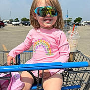 Rae joined the competition — help win amazing prizes! child, shopping_cart, sunglasses, pink_shirt, rainbow_design, parking_lot, drink, sunny, smile, happy, outdoor, reflection, casual_clothing, legs, hand, daytime, retail, store_parking, person, summer