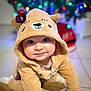 Vittorio participe au concours pour gagner de l'argent avec cette photo : baby, infant, child, bear_hoodie, costume, hood, cute, smile, eyes, portrait, bokeh, christmas_tree, holiday_lights, indoor, tiles, crawling, plush, bow, soft_texture, cozy