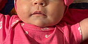 Scarlett joined the competition — help win amazing prizes! baby, infant, pink_clothing, headband, bow, hello_kitty, face, eyes, mouth, hand, quilt, fabric, pattern, cute, child, portrait, laying_down, indoors, skin, apparel