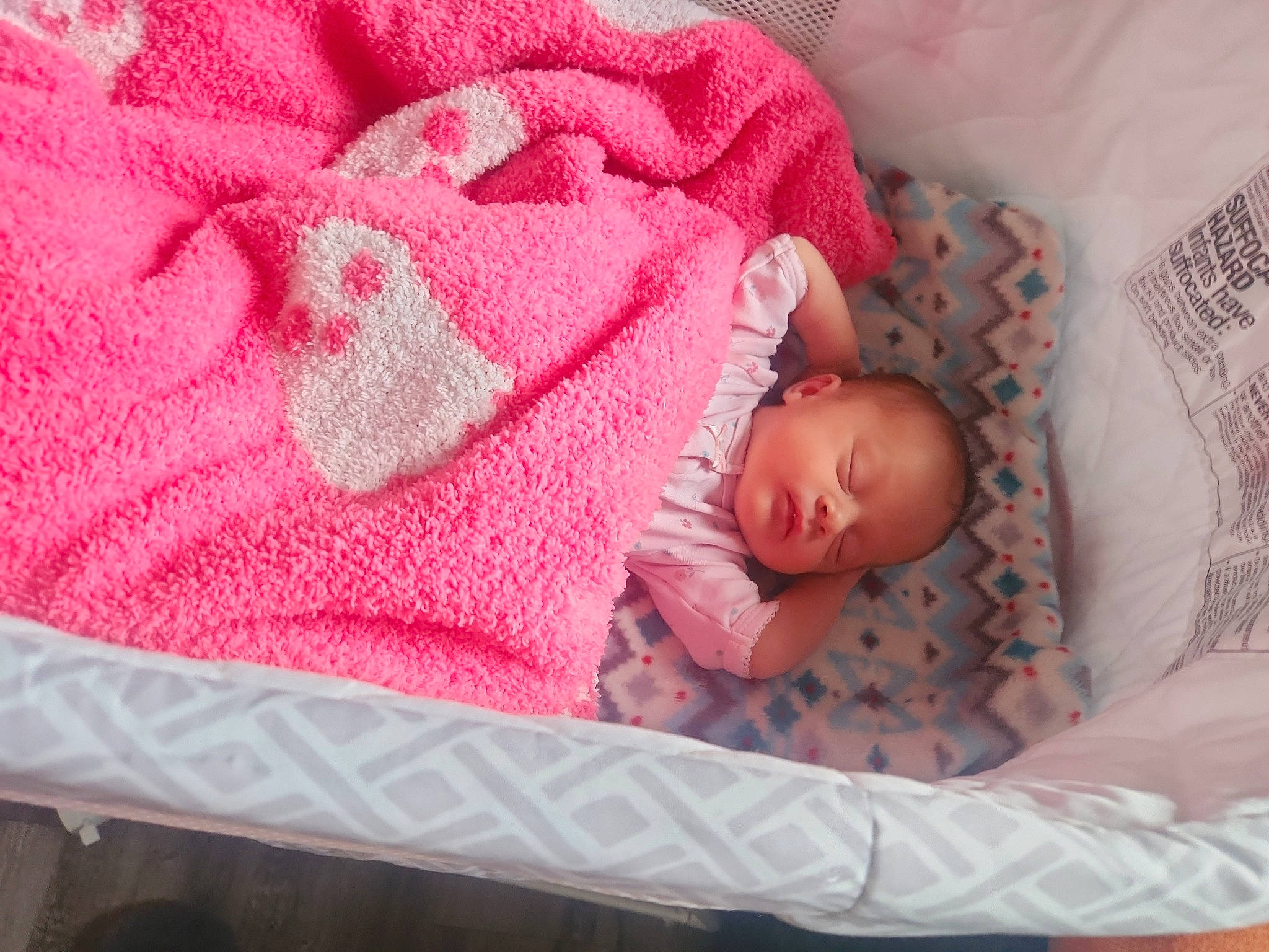 Sabrina is registered to the contest to win money with this photo: baby, baby_products, baby_sleeping, baby_toddler_clothing, bedding, bedtime, carmine, child, comfort, creative_arts, hand, linens, magenta, nap, pattern, person, pink, product, room, textile