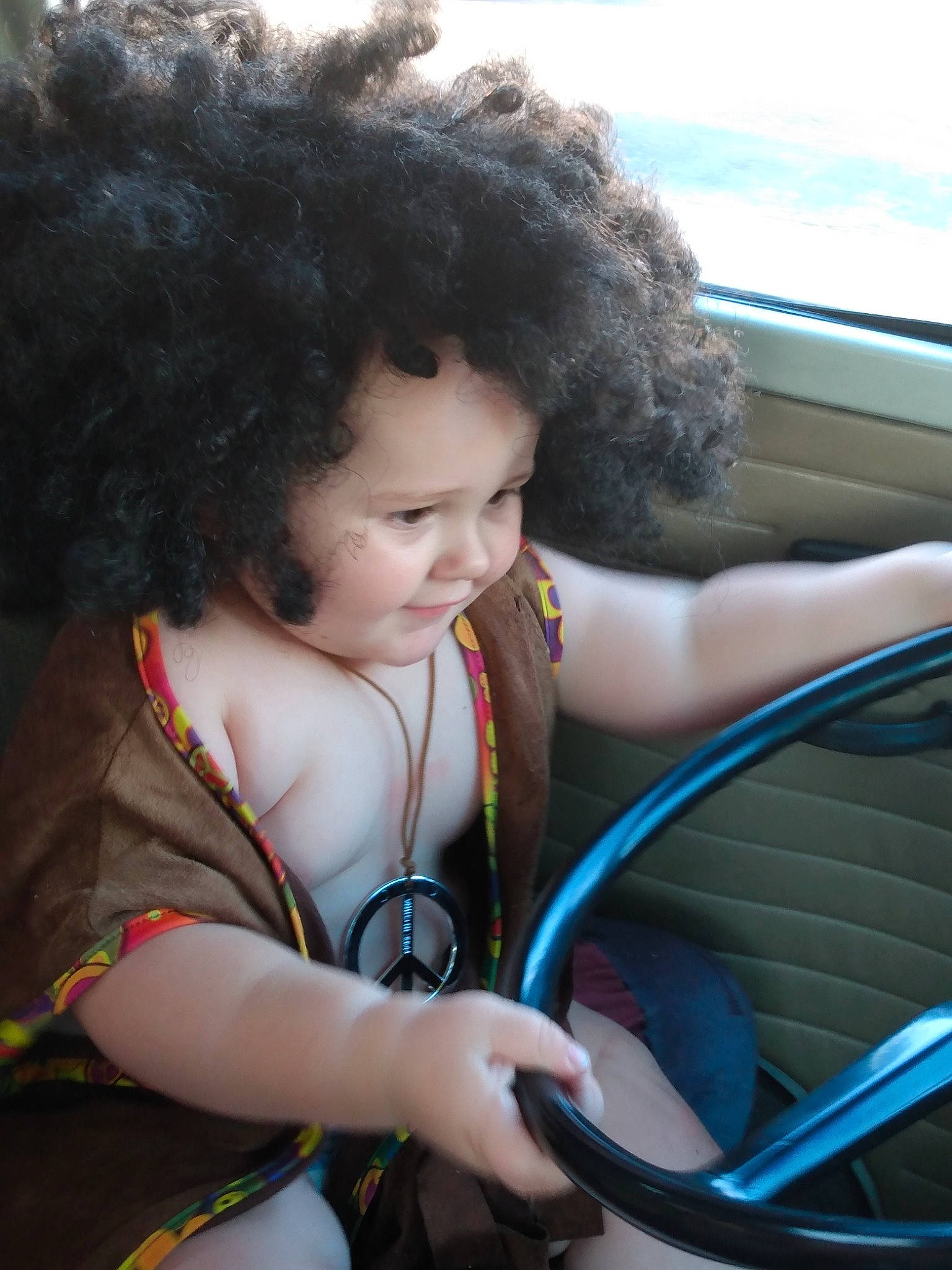 Noah joined the competition — help win amazing prizes! afro, auto_part, automotive_exterior, cool, electric_blue, eye, fun, grass, hand, happy, hood, leisure, motor_vehicle, person, sitting, skin, smile, steering_wheel, toddler, vehicle_door