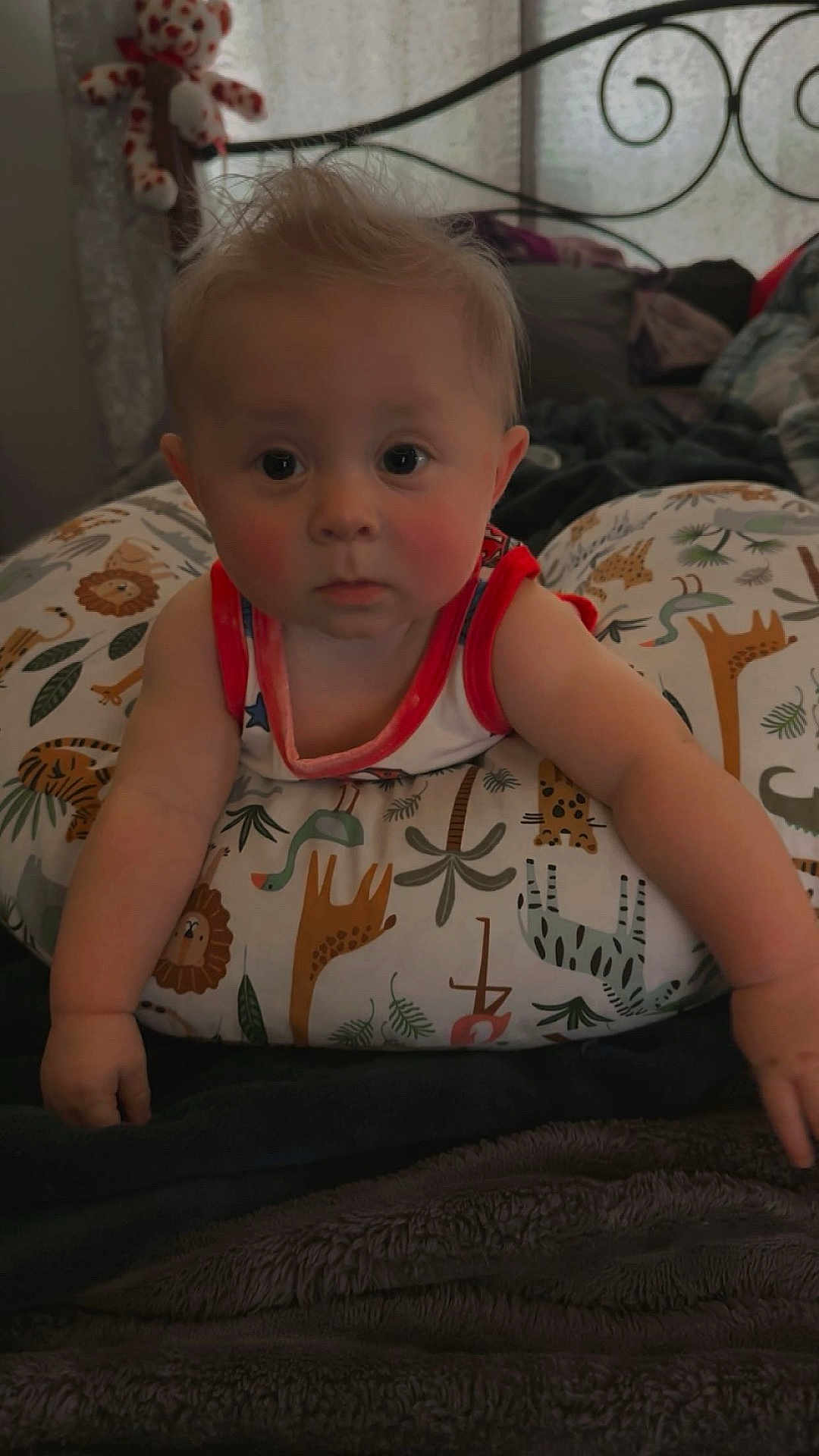 Kingston joined the competition — help win amazing prizes! baby, infant, child, pillow, animal_print, bedroom, blanket, face, person, curly_hair, red_trim_clothing, cute, indoors, soft_lighting, stuffed_toy, bed_frame, expression, toddler, resting, comfort